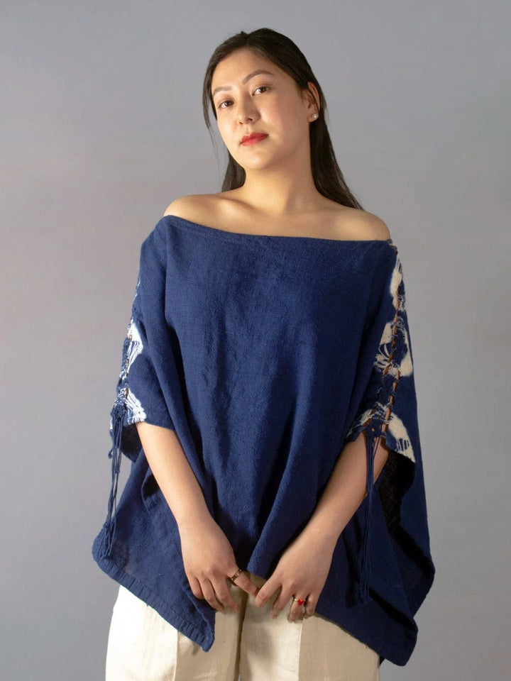 Wanderlust Indigo Poncho Handmade Handspun & Handwoven Kala Cotton with a macrame panel running through the garment, this piece is dip tie & dyed in Azo-free Indigo The Humane Collective